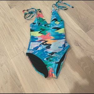 Solid and stripped The Olympia one piece bathing suit.